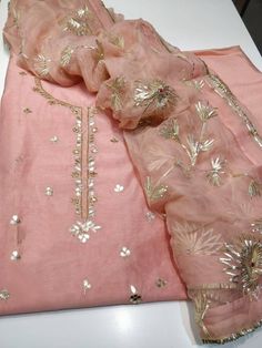 Item Overview ATHARVA Hand Embroidered Salwar Kameez * Beautiful Hand Embroidered Salwar Kameez * Beautiful Embroidered Neck /Jaal in Pink. * Beautiful Gota Pati Work Dupatta Fabric: * Shirt Chanderi Silk 2.5 Mts, * Dupatta: Pure Chiffon Chinnon 2.5 Mts (W/Gota Work Jaal) * Bottom Santoon 2.5 Mts. Excusive Hand Embroidered Party Wear Punjabi Suit. Customization: * Fabrics: Designs Can be made in different Fabrics. * Stitching Available Care: *Dry Clean/ Avoid direct Ironing on Embroidery Part. * Festive Kurta With Resham Embroidery In Shantoon, Festive Shantoon Kurta With Resham Embroidery, Festive Resham Embroidered Shantoon Churidar, Festive Shantoon Churidar With Resham Embroidery, Fitted Embroidered Fabric With Gota Work For Designer Wear, Fitted Embroidered Fabric With Gota Work For Festivals, Festive Raw Silk Unstitched Suit With Gota Work, Fitted Bollywood Embroidered Fabric With Gota Work, Festive Tissue Silk Kurta With Embroidery