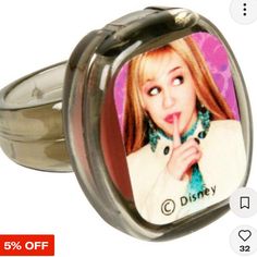 a ring with an image of a woman sticking her tongue out and saying, disney on it