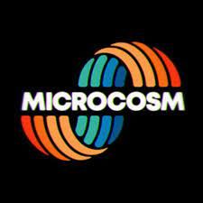 the microcosm logo is shown on a black background, with an orange and blue circle