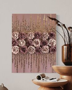 a painting with pink roses hanging on the wall