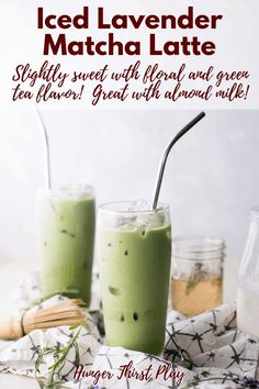 two glasses filled with green tea and topped with sprinkles on a table