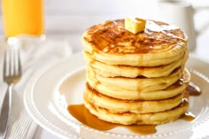 a stack of pancakes on a plate with syrup