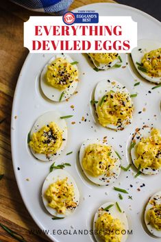 deviled eggs on a white plate with sprinkles and seasoning around them