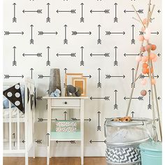 a baby's room with an arrow wall decal