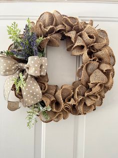 a burlock wreath with lavenders and greenery hangs on the front door