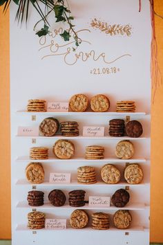 cookies and cookies are displayed on shelves in front of a wedding sign that says, i do