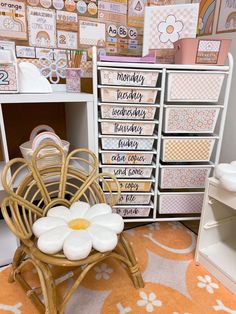 an organized craft room with lots of drawers and paper work on the wall behind it