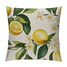 a pillow with lemons, flowers and leaves on the front is featured in this image