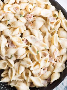 a skillet filled with pasta and meat