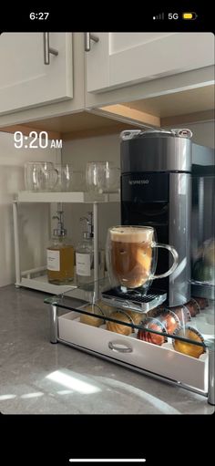 the coffee maker is on display in the kitchen