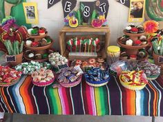 a mexican themed dessert table with lots of candy