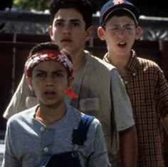 three young boys standing next to each other