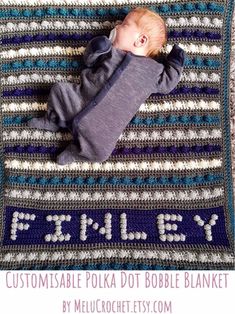 a baby laying on top of a blanket with the words family written in white and blue