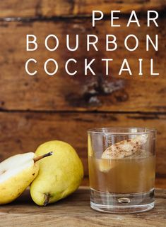 pear bourbon cocktail in a glass next to two pears