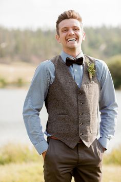 a man wearing a vest and bow tie