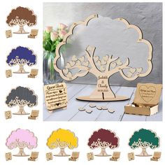 the wooden tree is next to several different colored trees with hearts on them and two small boxes