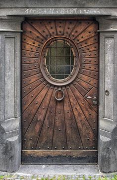 an old door with a circular window on it