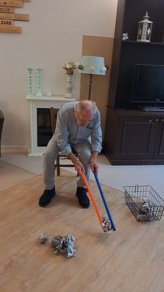 an older man is cleaning the floor with a mop