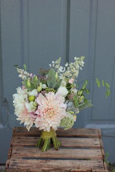 a bouquet of flowers sitting on top of a wooden crate