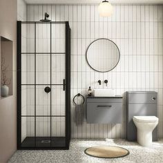 a bathroom with a toilet, sink and shower stall in white tile on the floor