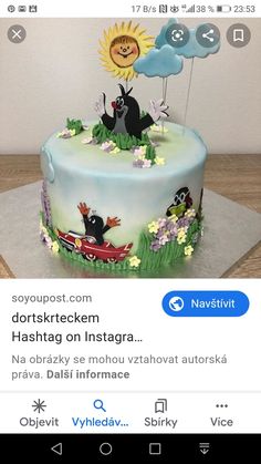 the cake is decorated with an image of two cats and a bird on top of it