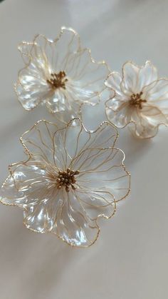 three glass flowers sitting on top of a table