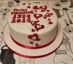 a white cake with red and white hearts on it