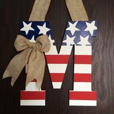 the letter m is made out of wood and has an american flag design on it