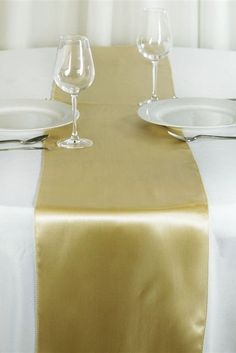 the table is set with two wine glasses and one empty glass on top of it