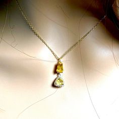 This is part of Chairish’s Fine Jewelry assortment.  Introducing our exquisite Yellow Sapphire and Halo Diamond Gold Drop Pendant—a timeless masterpiece that embodies elegance and sophistication. This meticulously crafted pendant is a harmonious blend of precious gemstones and fine craftsmanship, designed to enhance your style and captivate your senses. At the heart of this pendant lies a stunning 1.35 carat Baguette and Triangle Ceylon Yellow Sapphire, weighing 0.75 carat, radiating a brilliant yellow hue that symbolizes joy, wisdom, and prosperity. The sapphire's vibrant color is reminiscent of sunny days and carries a sense of optimism that effortlessly brightens any ensemble. Accompanying the Yellow Sapphire is a delicate 0.35 carat Diamond, which adds a touch of glamour and refinement Diamond Gold, Yellow Sapphire, Drop Pendant, Precious Gemstones, Sapphire Diamond, Halo Diamond, Heart Pendant, Sunny Days, Gold Diamond