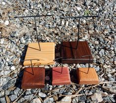 four wooden chairs sitting on top of a rocky ground