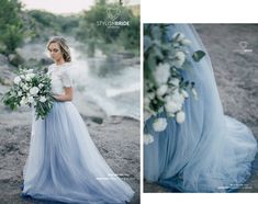 a woman in a blue dress holding a bouquet and standing next to a river with white flowers