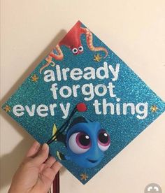 someone is holding up a blue graduation cap that says, already forgot everything on it