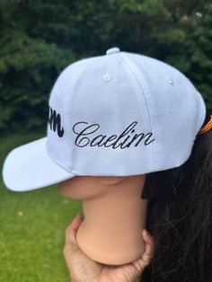 a woman wearing a cap with the word coolin on it's front and side