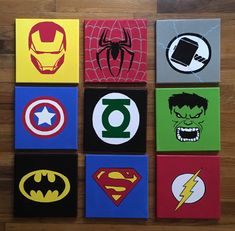 six square paintings with different superhero logos on them, all painted in various colors and sizes