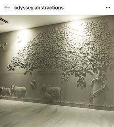 the wall is made out of metal and has animals on it