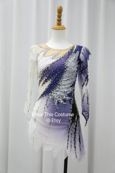 a white and purple dress on a mannequin headdress with sequins