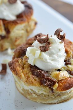 two desserts on a white plate with whipped cream