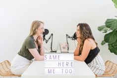 two women sitting at a table talking to each other