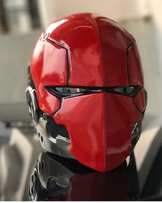 a red helmet sitting on top of a table