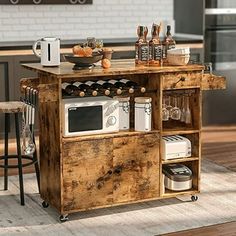 a kitchen island made out of wood with an oven, microwave and toaster on it