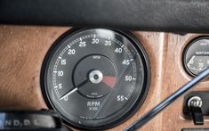 an old car dashboard with gauges and meter