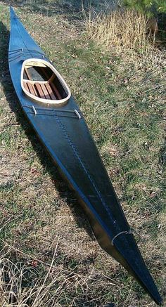 a canoe sitting on the ground with its oar resting on it's side