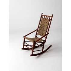 a wooden rocking chair with an upholstered seat and back cushion, on a white background