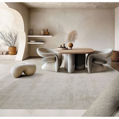 a table and chairs in a room with white carpeted flooring on the walls