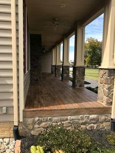 the front porch is covered with stone and wood