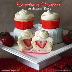 strawberry cupcakes with cream cheese frosting and strawberries on a white tray