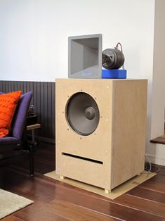 a speaker sitting on top of a wooden box