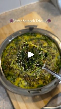 a bowl filled with broccoli on top of a wooden cutting board