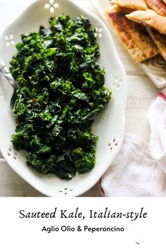 a white plate topped with greens next to bread